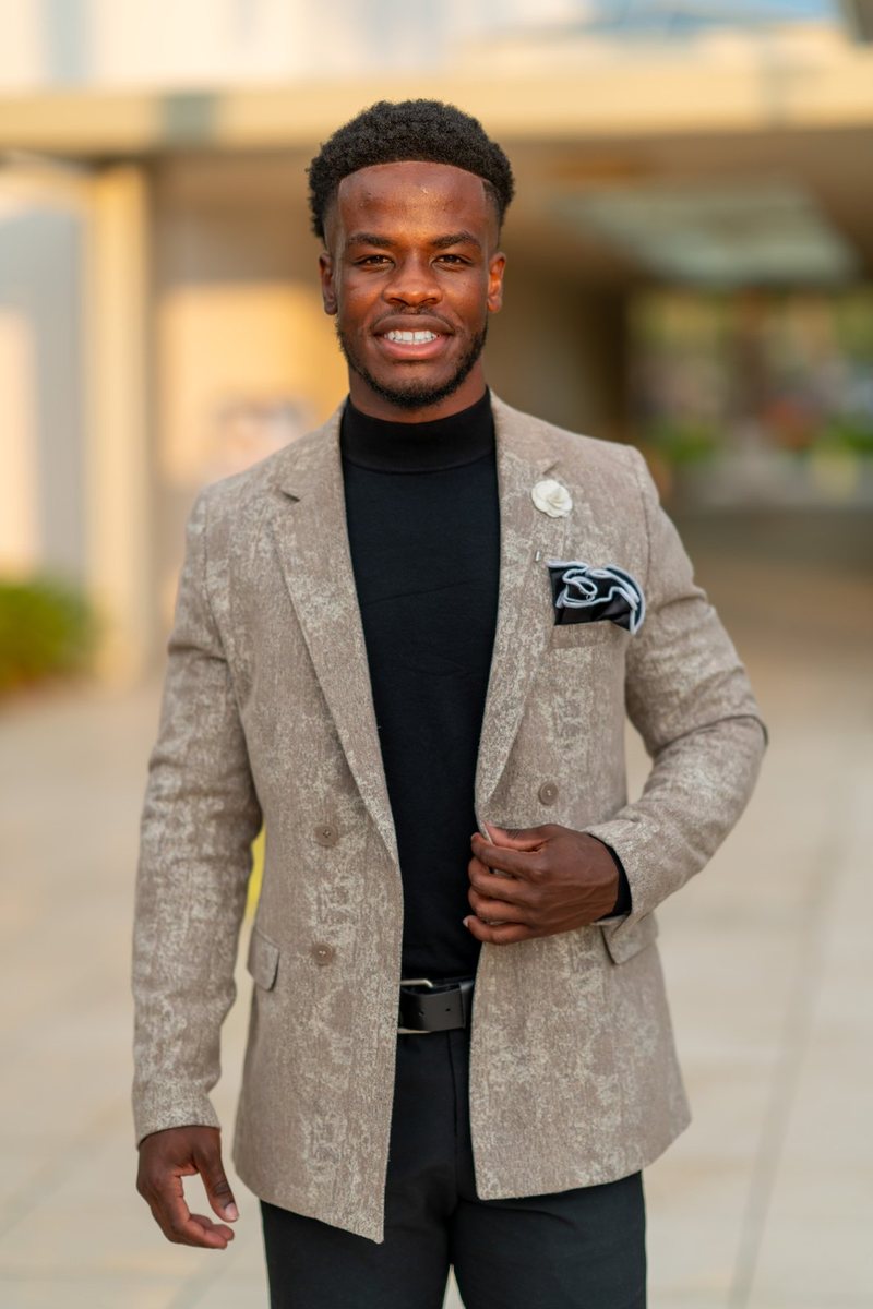 Portrait of Darhyl R. Alusma in a tan blazer